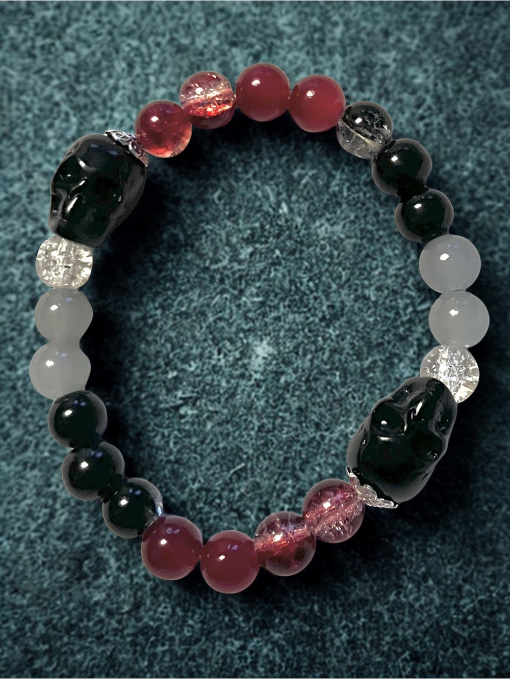 Ruby’s black skull bracelet/red